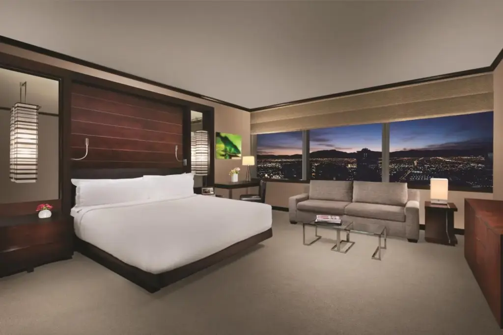 a bedroom with a large white bed and a couch at Vdara Hotel & Spa at ARIA Las Vegas in Las Vegas