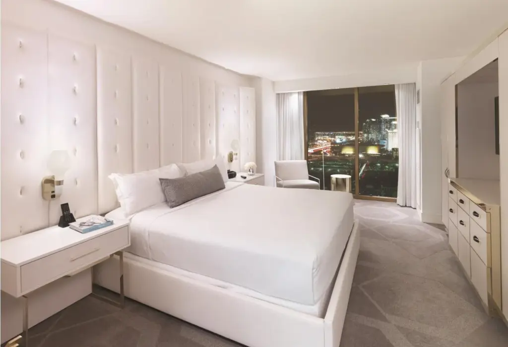 W Las Vegas suite bedroom with a white king bed