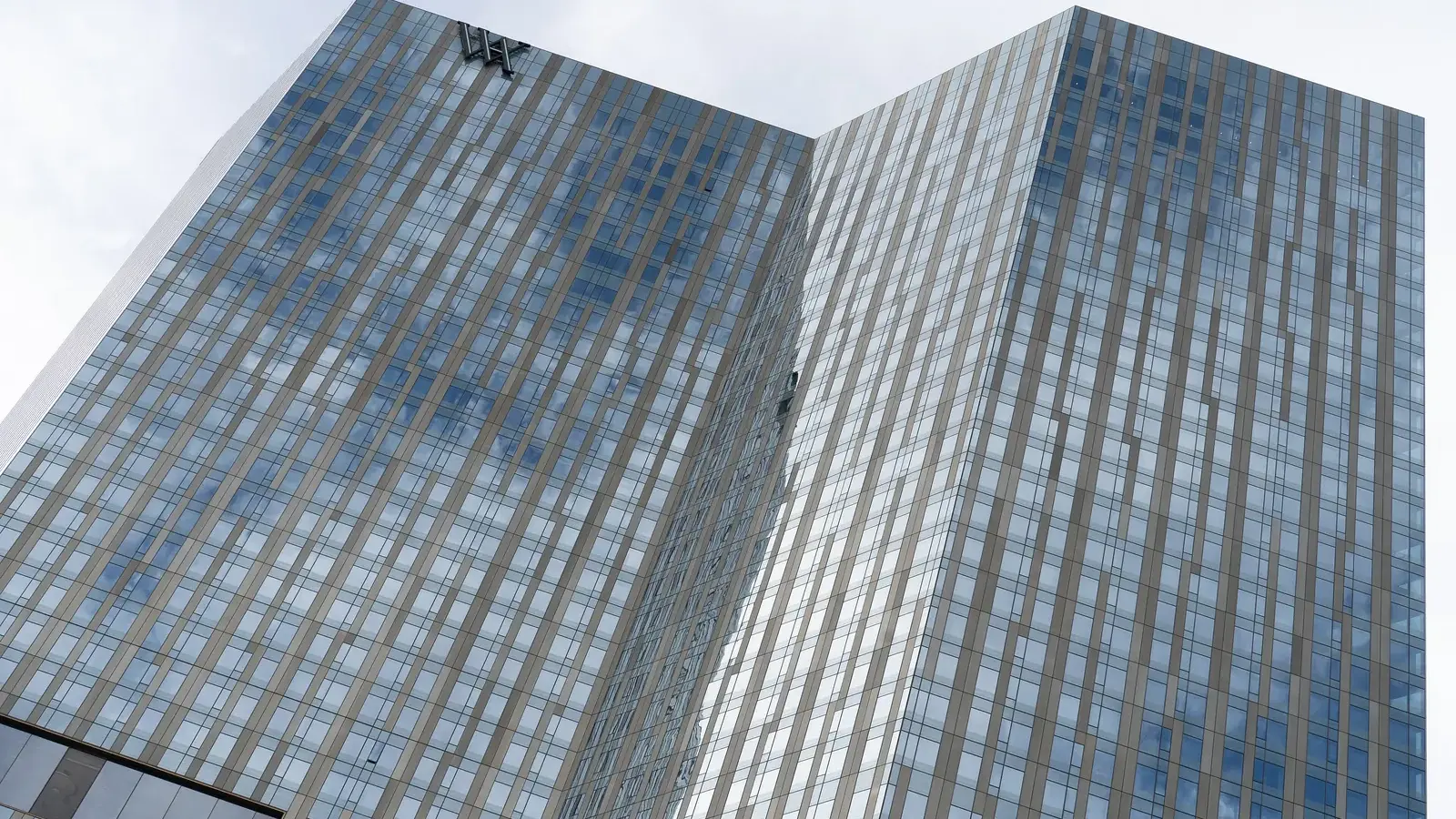 The glass tower of the Waldorf Astoria Las Vegas with the WA logo at the top