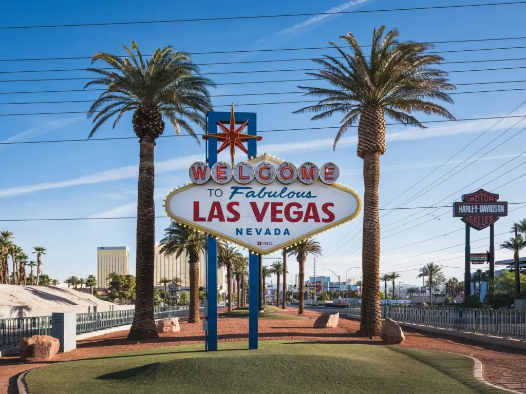 The Welcome to Fabulous Las Vegas sign under palm trees