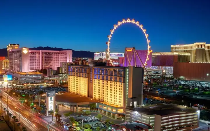 a city skyline with a ferris wheel at night at The Westin Las Vegas Hotel & Spa in Las Vegas