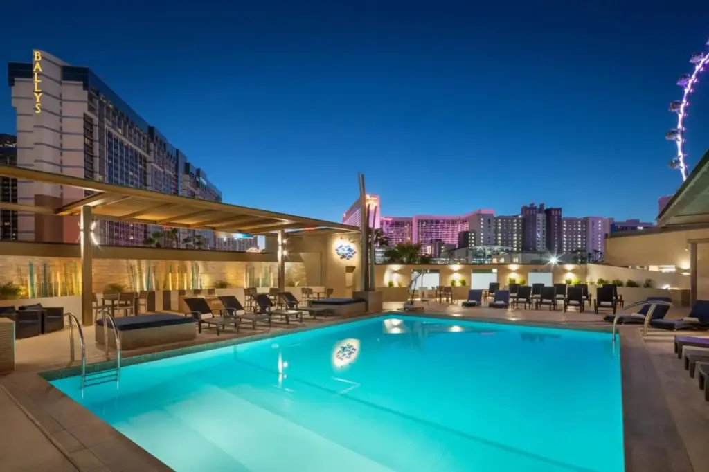 a pool with a view of the city at night at The Westin Las Vegas Hotel & Spa in Las Vegas