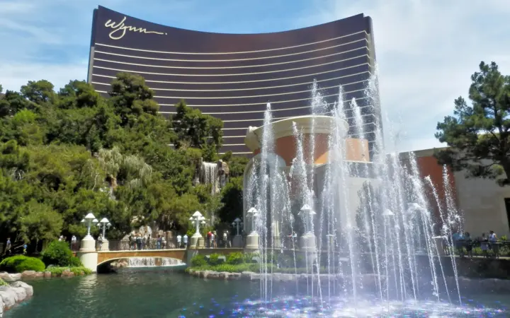 Wynn Las Vegas tower rising behind its lake and fountains