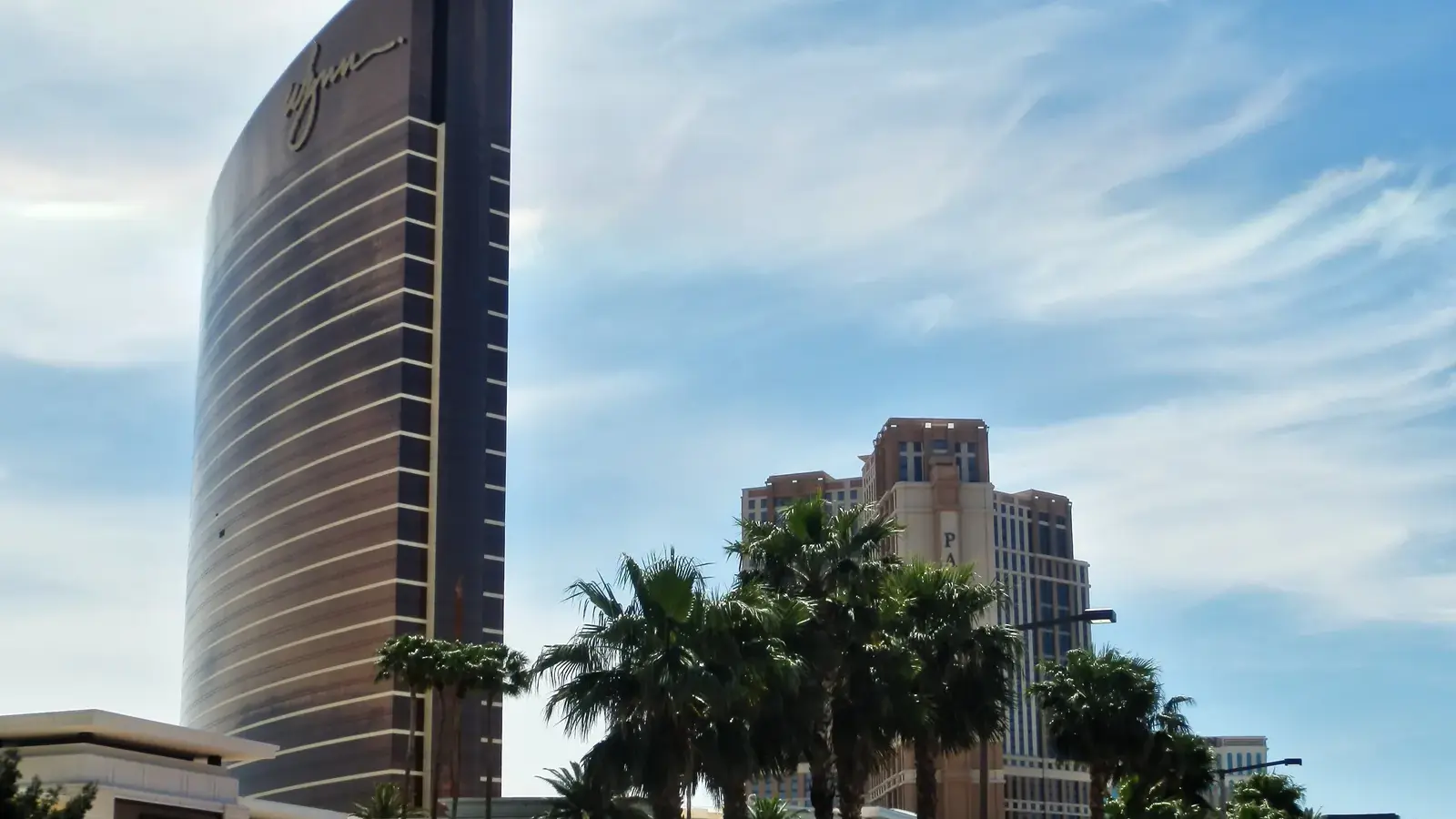 Wynn Las Vegas tower beside the Palazzo tower under a blue sky on the Las Vegas Strip
